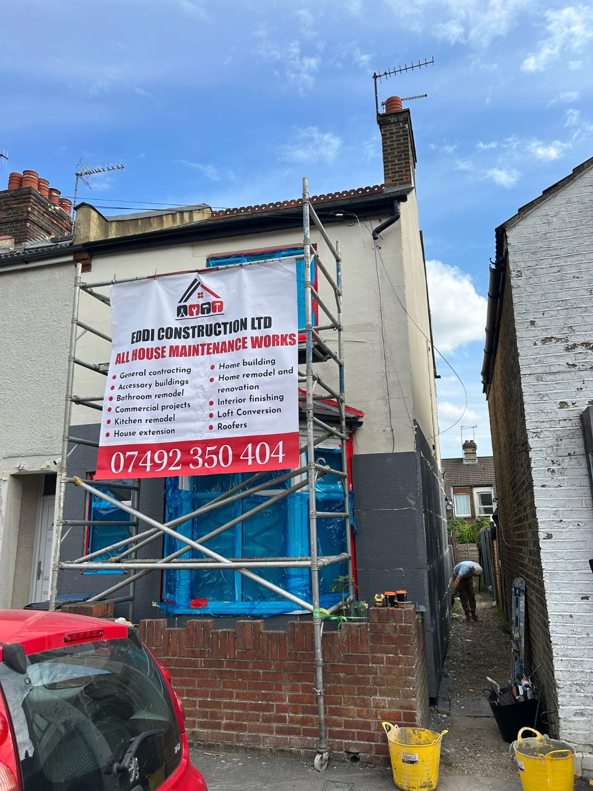 Eddi Construction Ltd branded scaffolding on house renovation