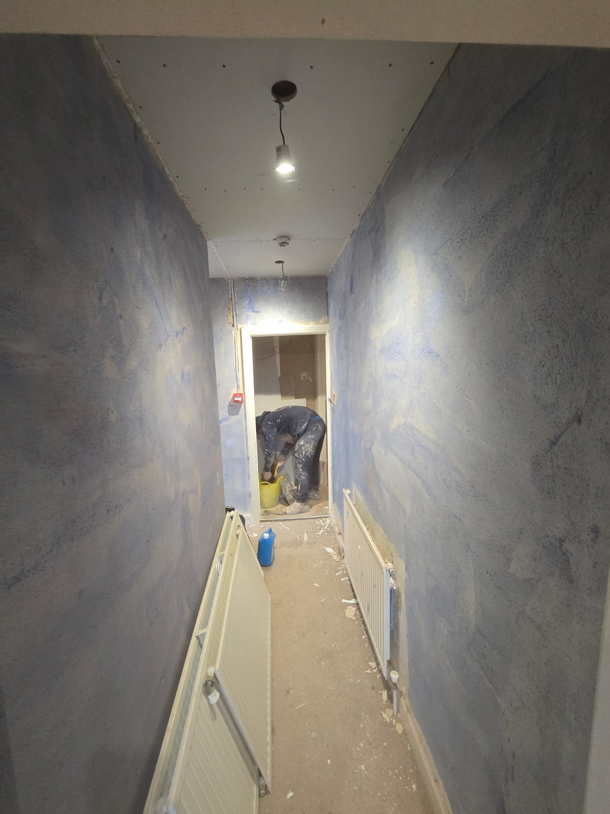 Corridor with new plaster and radiator installed